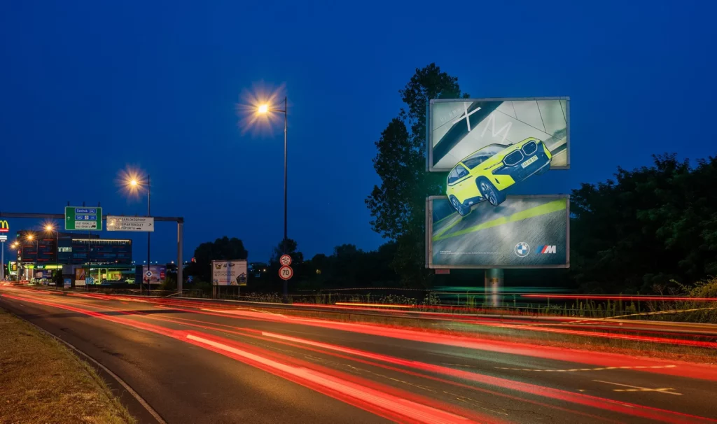Giant advertising banner on billboard with 2D elements for BMW in Budapest, Hungary