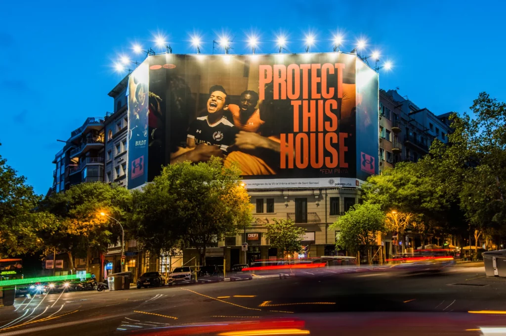 Protect This house campaign for Under Armour in Barcelona, Spain, with a giant advertising banner - Night view